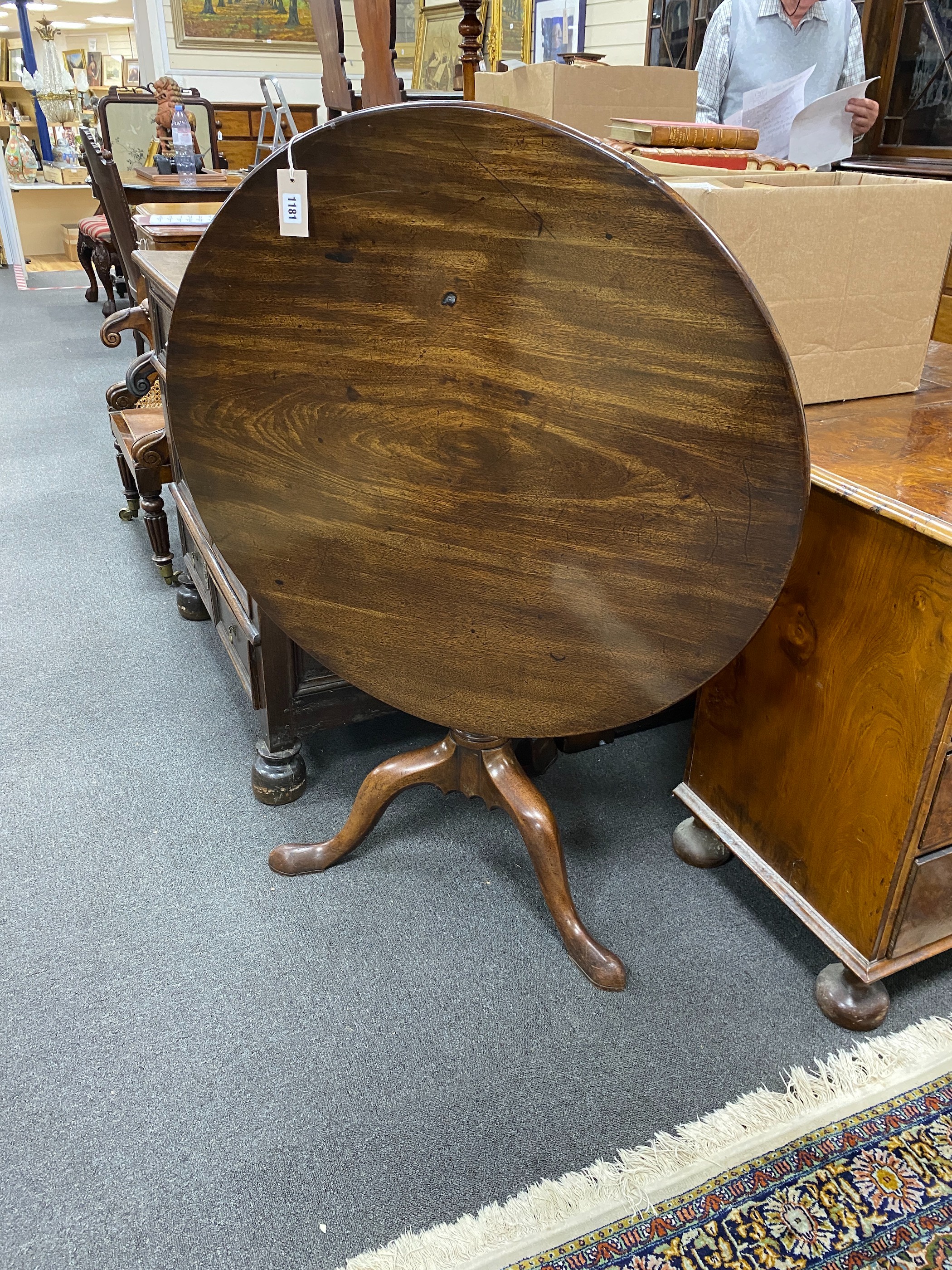 A George III and later circular mahogany tilt top tea table with birdcage alignment, diameter 86cm, height 70cm